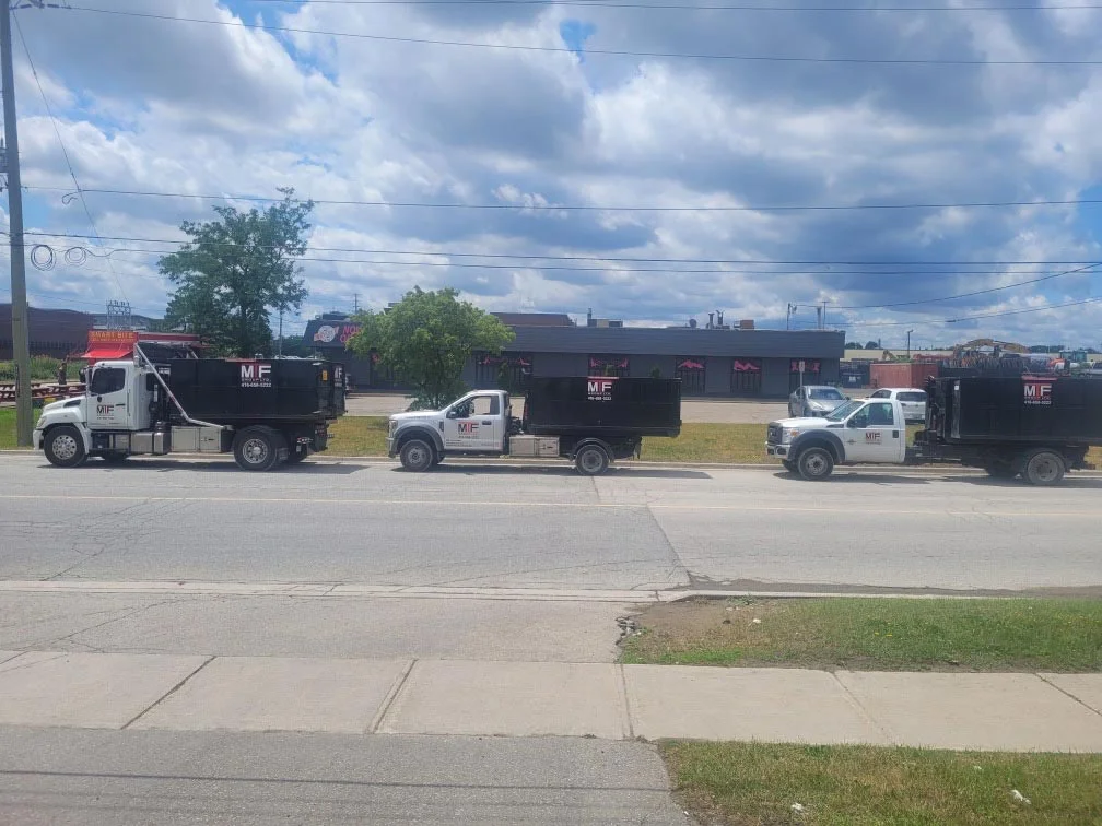 Three MTF Group dumpster trucks