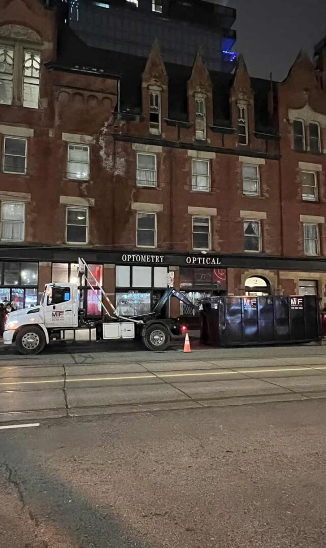 Truck loading a dumpster bin